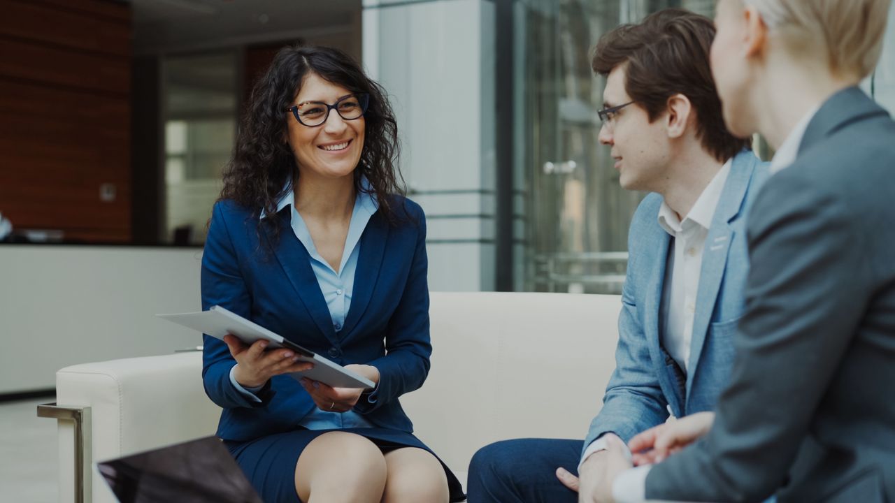 Home Professionals discussing business strategy in a corporate office setting.